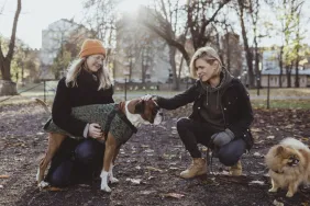 women with dogs showing good dog park etiquette